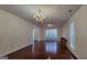 Spacious living room with hardwood floors, chandelier, and natural light from large windows at 7926 Palomino Pass, Riverdale, GA 30274