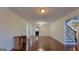 Bright, spacious living room with hardwood floors and staircase with decorative ironwork at 7926 Palomino Pass, Riverdale, GA 30274