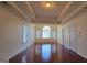 Large main bedroom featuring hardwood floors, a tray ceiling, and a grand window, providing a luxurious retreat at 7926 Palomino Pass, Riverdale, GA 30274