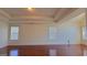 Spacious main bedroom with three large windows and hardwood floors, offering an abundance of natural light at 7926 Palomino Pass, Riverdale, GA 30274