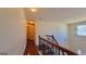 Hallway with wrought iron staircase, overhead lighting, and hardwood flooring at 7926 Palomino Pass, Riverdale, GA 30274