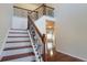 Elegant staircase with ornate iron railings and hardwood steps that lead to the main level of the home at 7926 Palomino Pass, Riverdale, GA 30274