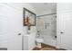 Bright bathroom featuring a tiled shower-tub combo with glass door, and decorative fixtures at 1500 Highway 155 North, Mcdonough, GA 30252