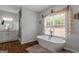 Elegant bathroom with a modern freestanding tub, shower and granite vanity at 1500 Highway 155 North, Mcdonough, GA 30252
