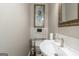 Cozy half-bath with modern sink and fixtures and decorative wall art at 1500 Highway 155 North, Mcdonough, GA 30252