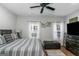 Bright bedroom with ceiling fan, neutral colored decor and two windows at 1500 Highway 155 North, Mcdonough, GA 30252
