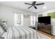 Bright bedroom with ceiling fan, and neutral colored decor and two windows at 1500 Highway 155 North, Mcdonough, GA 30252