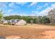 Landscaped single-story home on a vast, grassy lot, showcasing its picturesque setting at 1500 Highway 155 North, Mcdonough, GA 30252