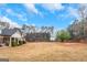 Expansive lawn framing a charming home with a covered front porch; blending comfort and nature at 1500 Highway 155 North, Mcdonough, GA 30252