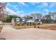 Sprawling single-story home with manicured lawn and dormer windows under a blue sky at 1500 Highway 155 North, Mcdonough, GA 30252