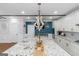 Bright kitchen with white cabinets, granite island with seating, pantry, white backsplash, and modern stainless steel appliances at 1500 Highway 155 North, Mcdonough, GA 30252