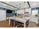 Modern kitchen with granite island has dark-gray base, white cabinets, stainless-steel appliances and a dark-blue accent wall at 1500 Highway 155 North, Mcdonough, GA 30252