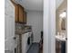 Functional laundry room with cabinets adjacent to a half-bath at 1500 Highway 155 North, Mcdonough, GA 30252