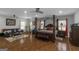 Large and luxurious main bedroom suite features a seating area, canopy bed, hardwood floors, and lots of natural light at 1500 Highway 155 North, Mcdonough, GA 30252