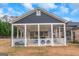 View of the enclosed poolside patio with outdoor furniture and a glimpse of the yard at 1500 Highway 155 North, Mcdonough, GA 30252