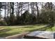 An ample-sized grassy backyard surrounded by mature trees for serene outdoor living at 3647 Glen Mora Dr, Decatur, GA 30032