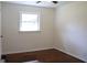 Inviting bedroom featuring hardwood floors, neutral walls, and ample natural light from the window at 3647 Glen Mora Dr, Decatur, GA 30032