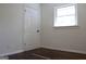 Cozy bedroom with hardwood floors, white trim, and a bright window creating a calming atmosphere at 3647 Glen Mora Dr, Decatur, GA 30032