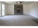 Spacious living room featuring a stone fireplace, carpet, and abundant natural light at 3647 Glen Mora Dr, Decatur, GA 30032