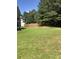 Spacious backyard with a well-maintained lawn and a tall wooden privacy fence at 7193 Cavender Sw Dr, South Fulton, GA 30331