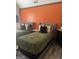 Comfortable bedroom with two upholstered beds, warm orange accent wall, and neutral bedding at 7193 Cavender Sw Dr, South Fulton, GA 30331