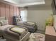 Bright bedroom featuring two twin beds, pink accent wall, and rainbow themed decor at 7193 Cavender Sw Dr, South Fulton, GA 30331