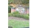 Stone community sign for Legacy at Cascading Creek with brick columns, lush landscaping, and well-maintained lawn at 7193 Cavender Sw Dr, South Fulton, GA 30331