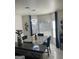 Dining area highlighted by modern light fixtures, window views, and stylish blue chairs at 7193 Cavender Sw Dr, South Fulton, GA 30331