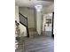 Inviting foyer showcasing modern decor, wood-look stairs, and stylish lighting at 7193 Cavender Sw Dr, South Fulton, GA 30331