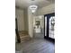 Bright foyer boasting updated lighting, a large mirror, and wood-look stairs at 7193 Cavender Sw Dr, South Fulton, GA 30331