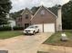 Charming two-story brick home with an attached two-car garage and well-maintained front lawn at 7193 Cavender Sw Dr, South Fulton, GA 30331