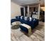 Open living area with stylish blue sectional, hardwood floors, and modern decor adjacent to main bedroom at 7193 Cavender Sw Dr, South Fulton, GA 30331