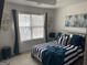 Bright main bedroom with natural light, a striking striped bedspread, and stylish decor at 7193 Cavender Sw Dr, South Fulton, GA 30331