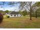 Expansive backyard with a patio, mature trees, and well-maintained lawn at 628 Morningside Dr, Stockbridge, GA 30281