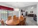 Traditional dining room featuring a wooden table, seating for six, and elegant lighting adjacent to the living room at 628 Morningside Dr, Stockbridge, GA 30281