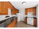Traditional kitchen with stainless sink, wood cabinetry, and white appliances at 628 Morningside Dr, Stockbridge, GA 30281