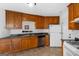 Traditional kitchen with stainless sink, wood cabinetry, and white appliances at 628 Morningside Dr, Stockbridge, GA 30281