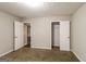 This bedroom features neutral walls, carpeted floors, and a walk-in closet at 136 Leguin Forest Dr, Locust Grove, GA 30248