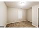 This bedroom features neutral walls, carpeted floors, and a bright window at 136 Leguin Forest Dr, Locust Grove, GA 30248