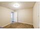 This bedroom features neutral walls, carpeted floors, and a bright window at 136 Leguin Forest Dr, Locust Grove, GA 30248