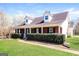 Inviting home featuring manicured front lawn and classic brick facade at 136 Leguin Forest Dr, Locust Grove, GA 30248