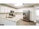 Well-equipped kitchen with white cabinets, granite counters, and stainless steel appliances at 136 Leguin Forest Dr, Locust Grove, GA 30248