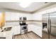 Modern kitchen featuring stainless steel appliances and ample cabinet space at 136 Leguin Forest Dr, Locust Grove, GA 30248