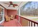 Relaxing back porch with wicker furniture and views of the backyard and mature trees at 643 Old Greenville Rd, Fayetteville, GA 30215