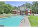 In-ground pool, backyard, patio furniture, and upper-level balcony on brick home at 643 Old Greenville Rd, Fayetteville, GA 30215