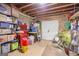 Unfinished basement with storage shelving, toolboxes, and a door leading to outside at 643 Old Greenville Rd, Fayetteville, GA 30215