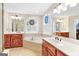 Relaxing bathroom with a soaking tub, double sinks, and custom windows at 643 Old Greenville Rd, Fayetteville, GA 30215