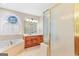 Bathroom with tiled shower, tub, and double sink vanity at 643 Old Greenville Rd, Fayetteville, GA 30215