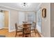 Bright dining area with hardwood floors, natural light, and a wooden table set with seating at 643 Old Greenville Rd, Fayetteville, GA 30215