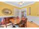 Elegant dining area with hardwood floors, large table, and classic decor at 643 Old Greenville Rd, Fayetteville, GA 30215